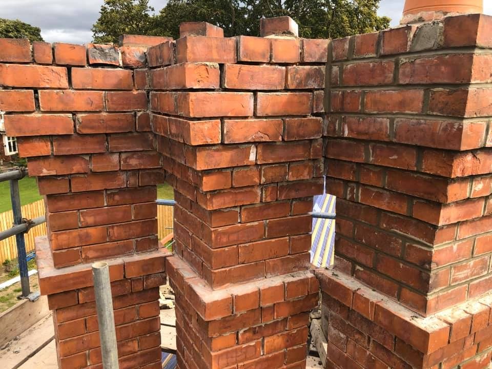 Close-up of newly built red brick chimney stacks