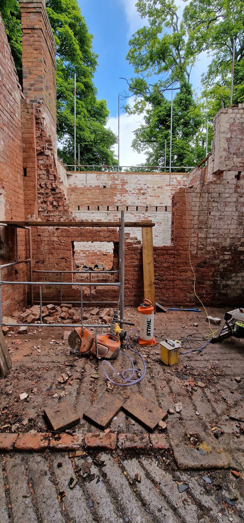 Brickwork in progress inside a build, courses laid to the line