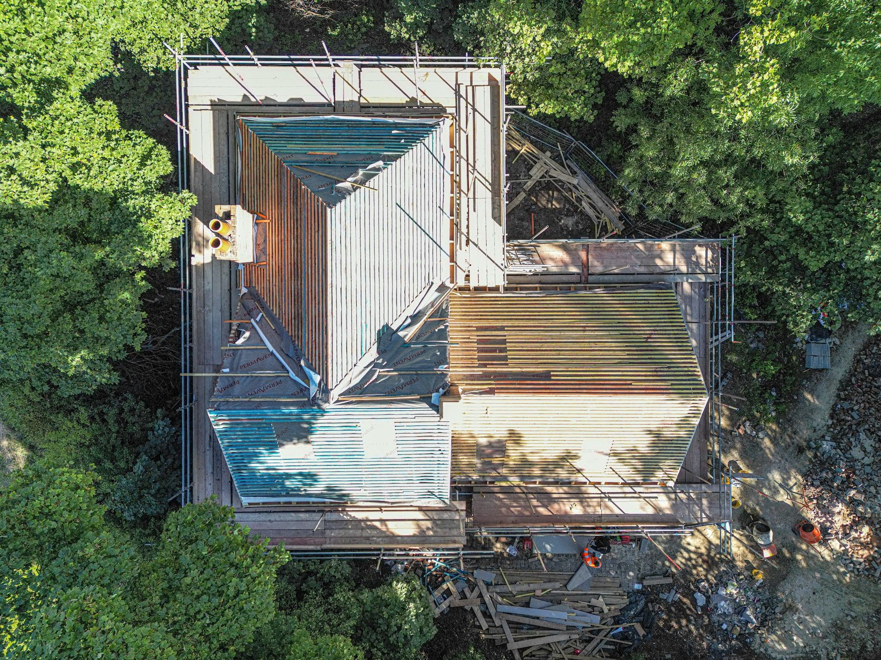 Drone view of a house under scaffold during roof works