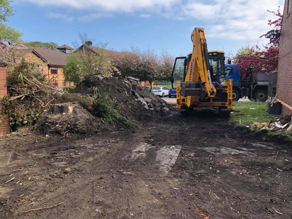 A digger clearing ground at the start of a build